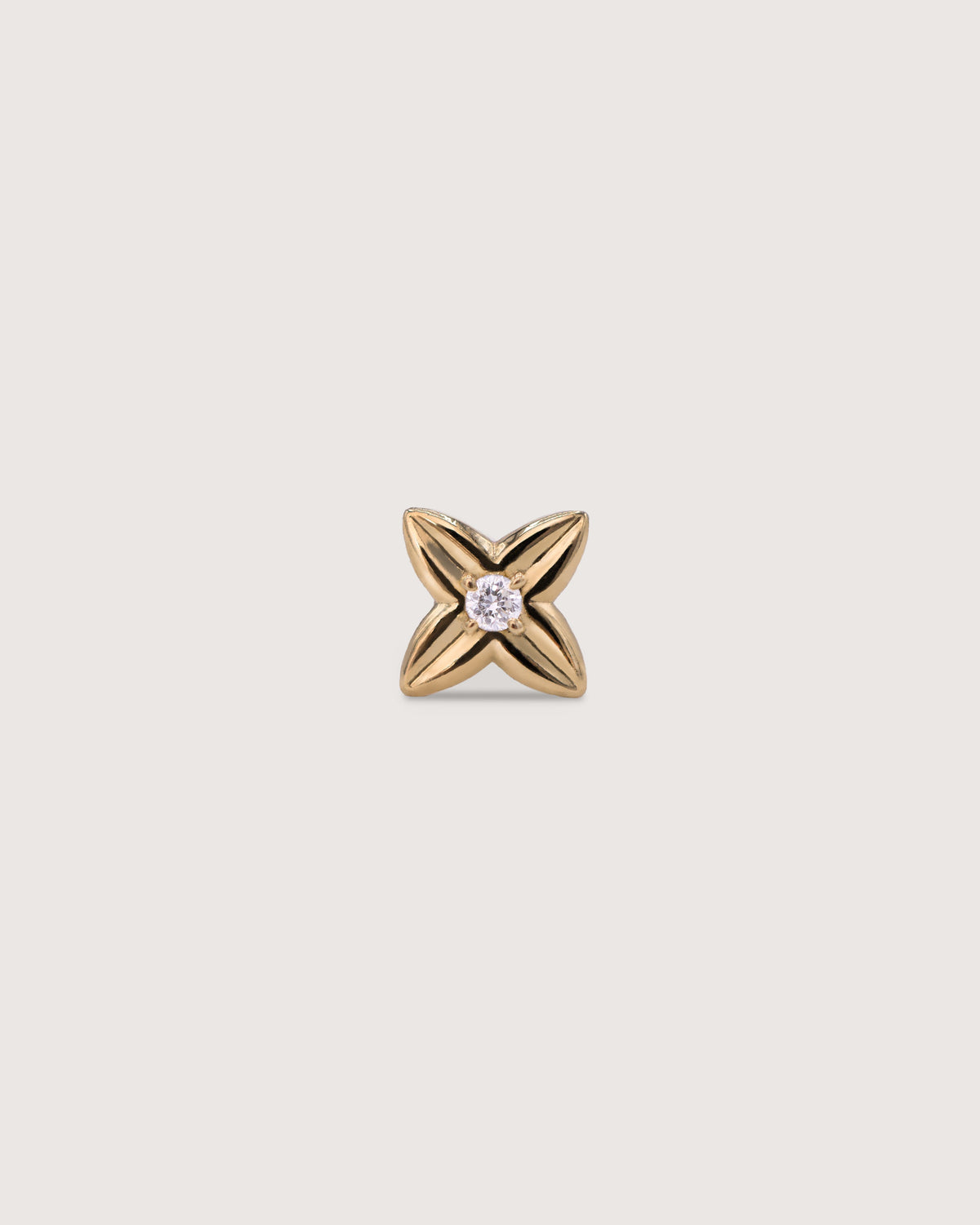 The Flora Stud earring in solid 14K gold, set with a 2mm diamond.