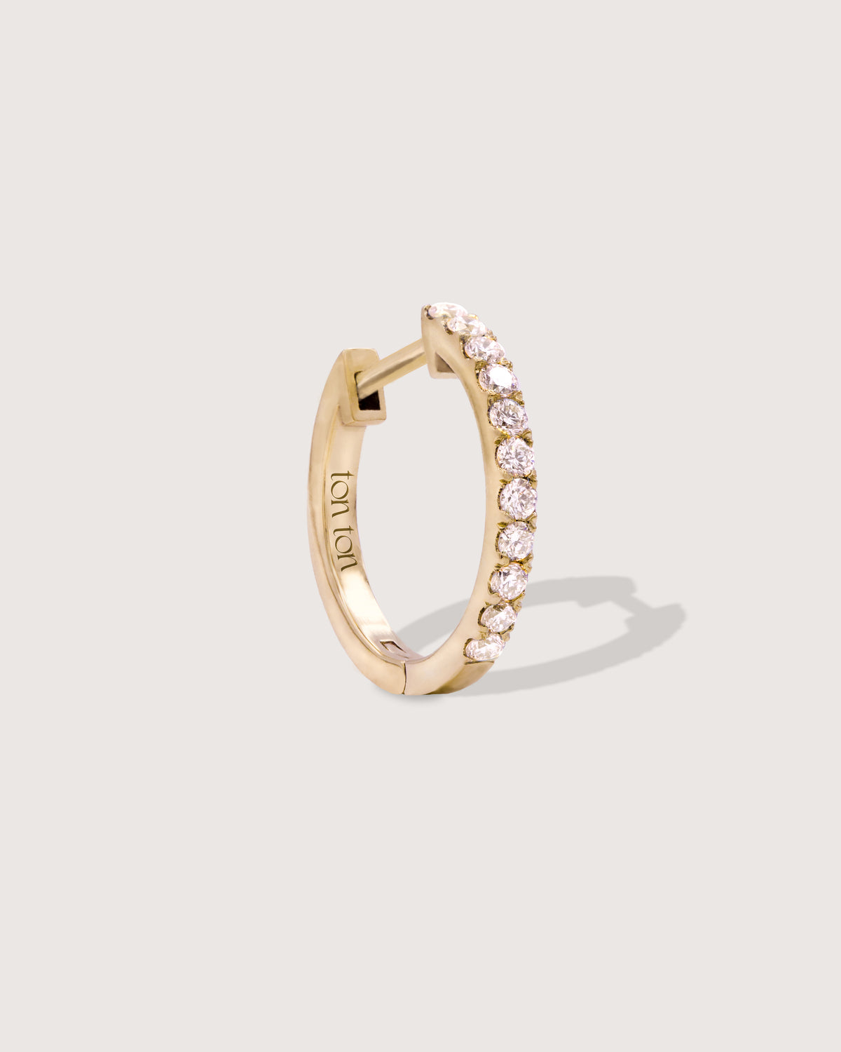 The Diamond Hoop earring in recycled solid 14K gold, set with 11 lab-grown diamonds.