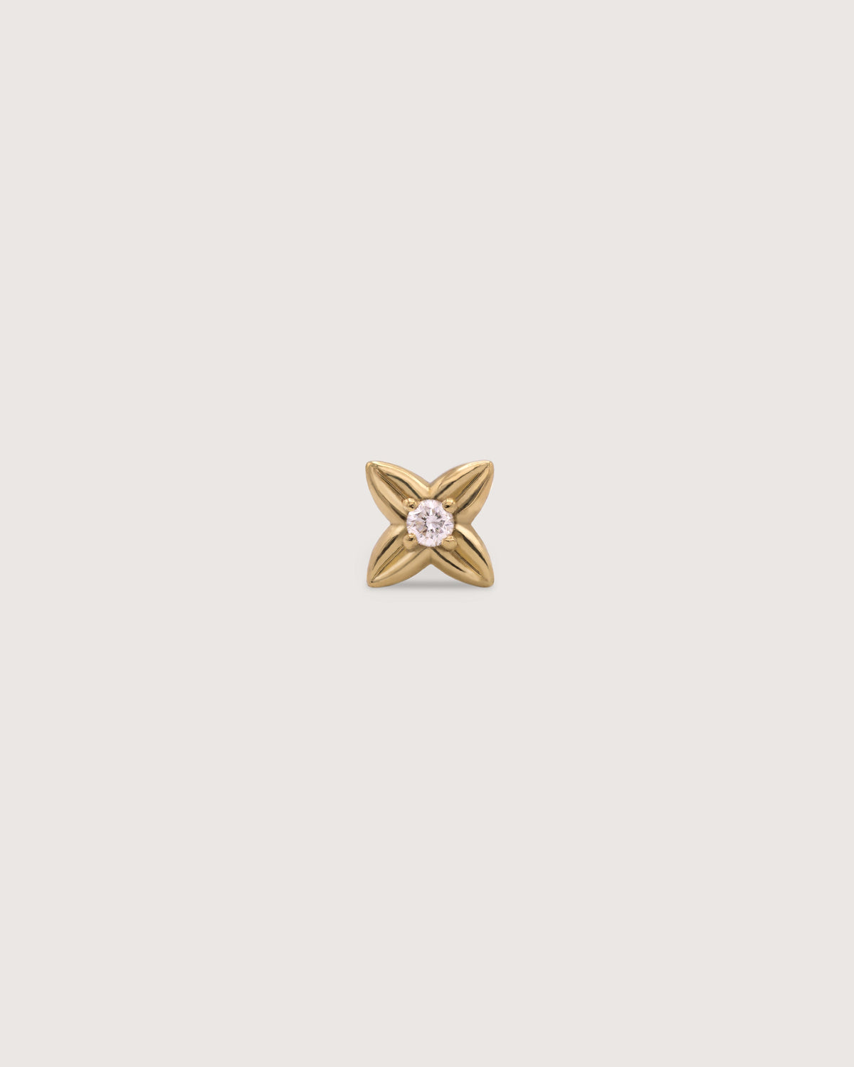 The Petite Flora Stud earring in solid 14K recycled gold, set with a 1.5mm diamond.
