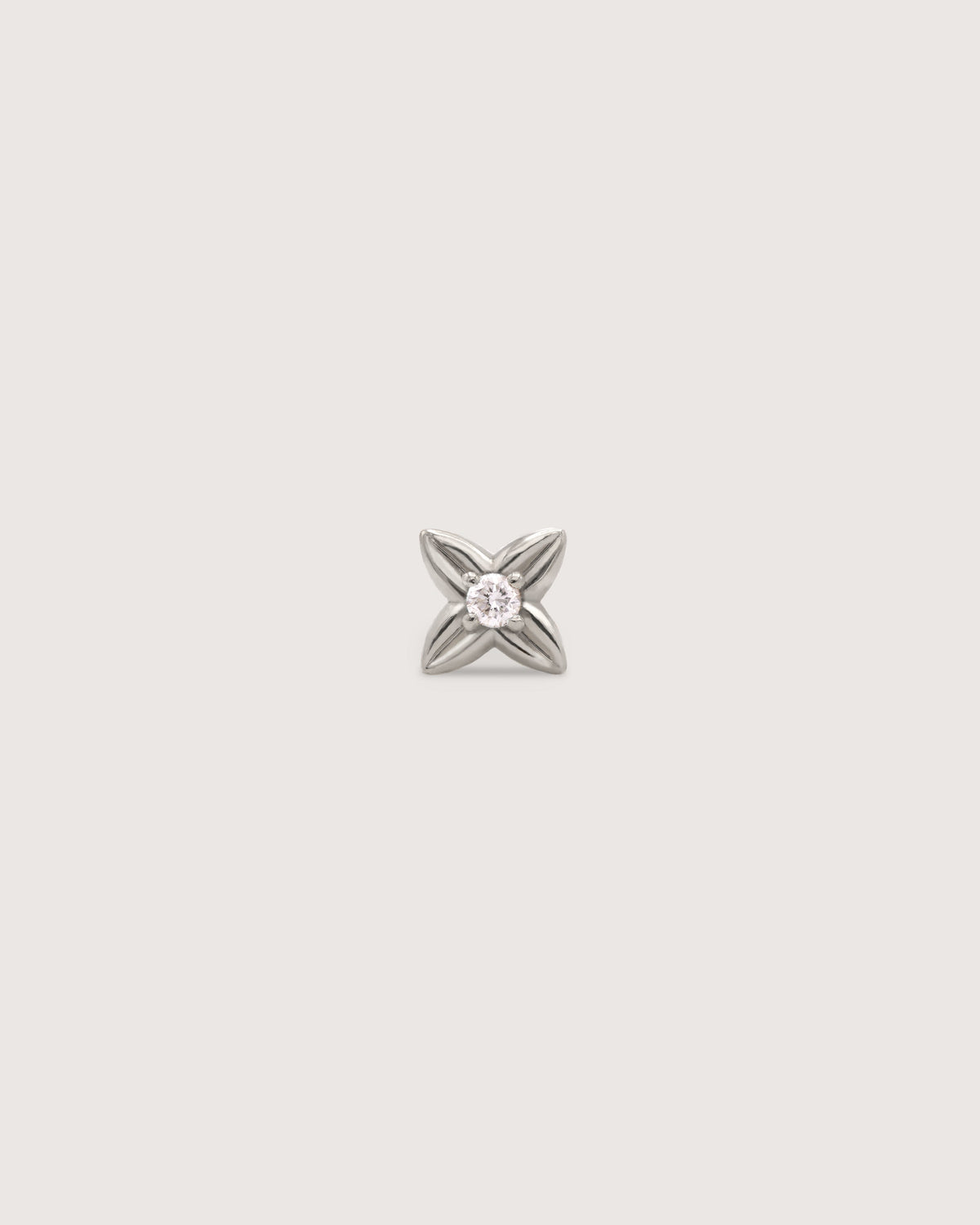 The Petite Flora Stud earring in solid 14K recycled white gold, set with a 1.5mm diamond.