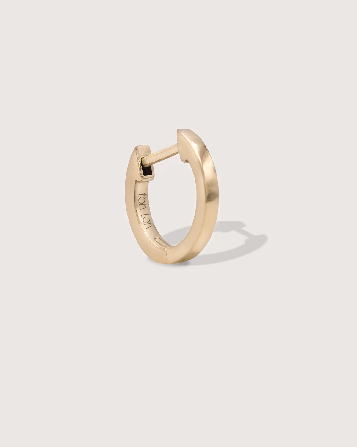 The Petite Hoop earring in recycled solid 14K gold, a smaller take on The Hoop with a secure click closure.