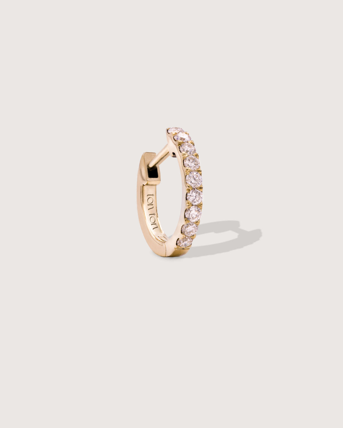 The Petite Diamond Hoop earring in recycled solid 14K gold, set with 9 lab-grown diamonds.