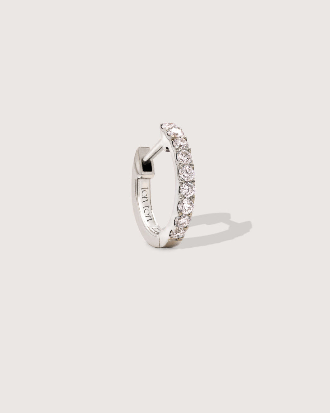 The Petite Diamond Hoop earring in recycled solid 14K white gold, set with 9 lab-grown diamonds.