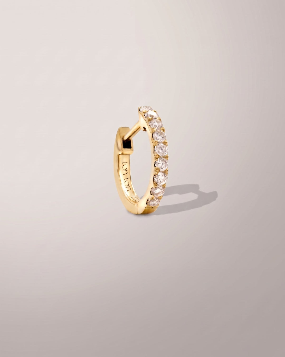 The Petite Diamond Hoop earring in recycled solid 14K gold, set with 9 lab-grown diamonds.