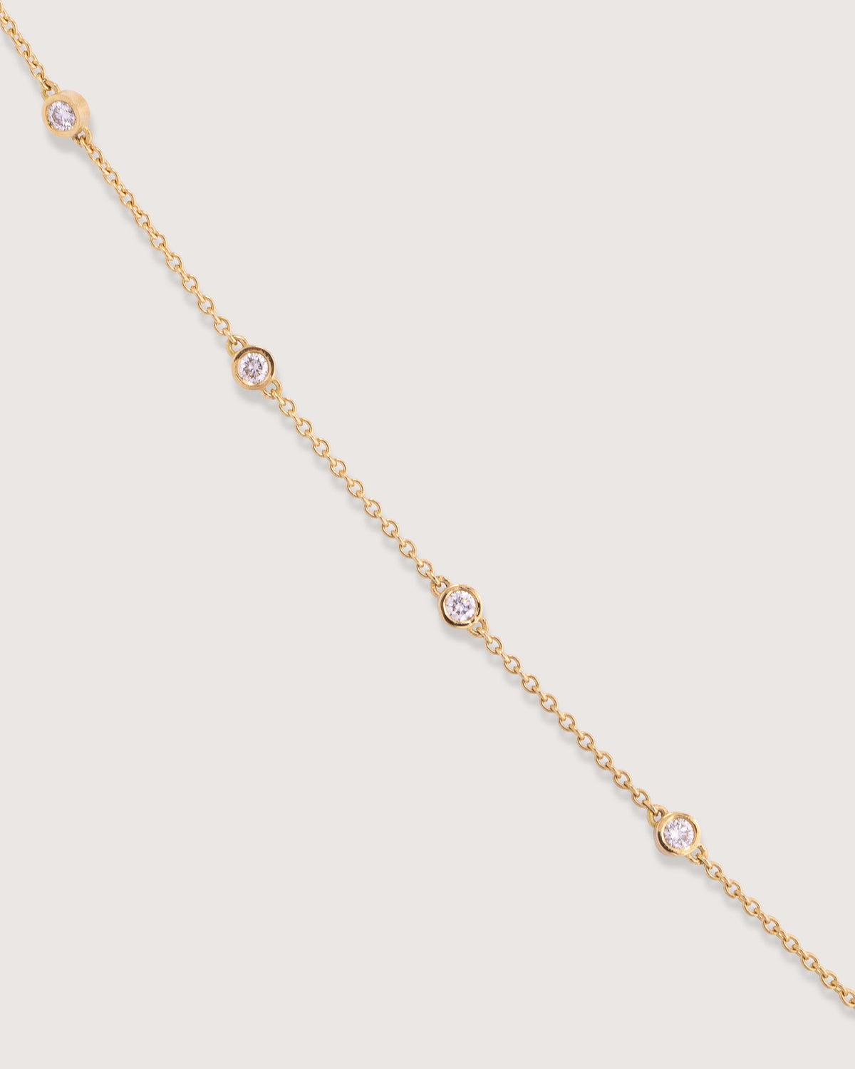 The Bezel Diamond Station Bracelet in recycled 18K gold, worn on the wrist.
