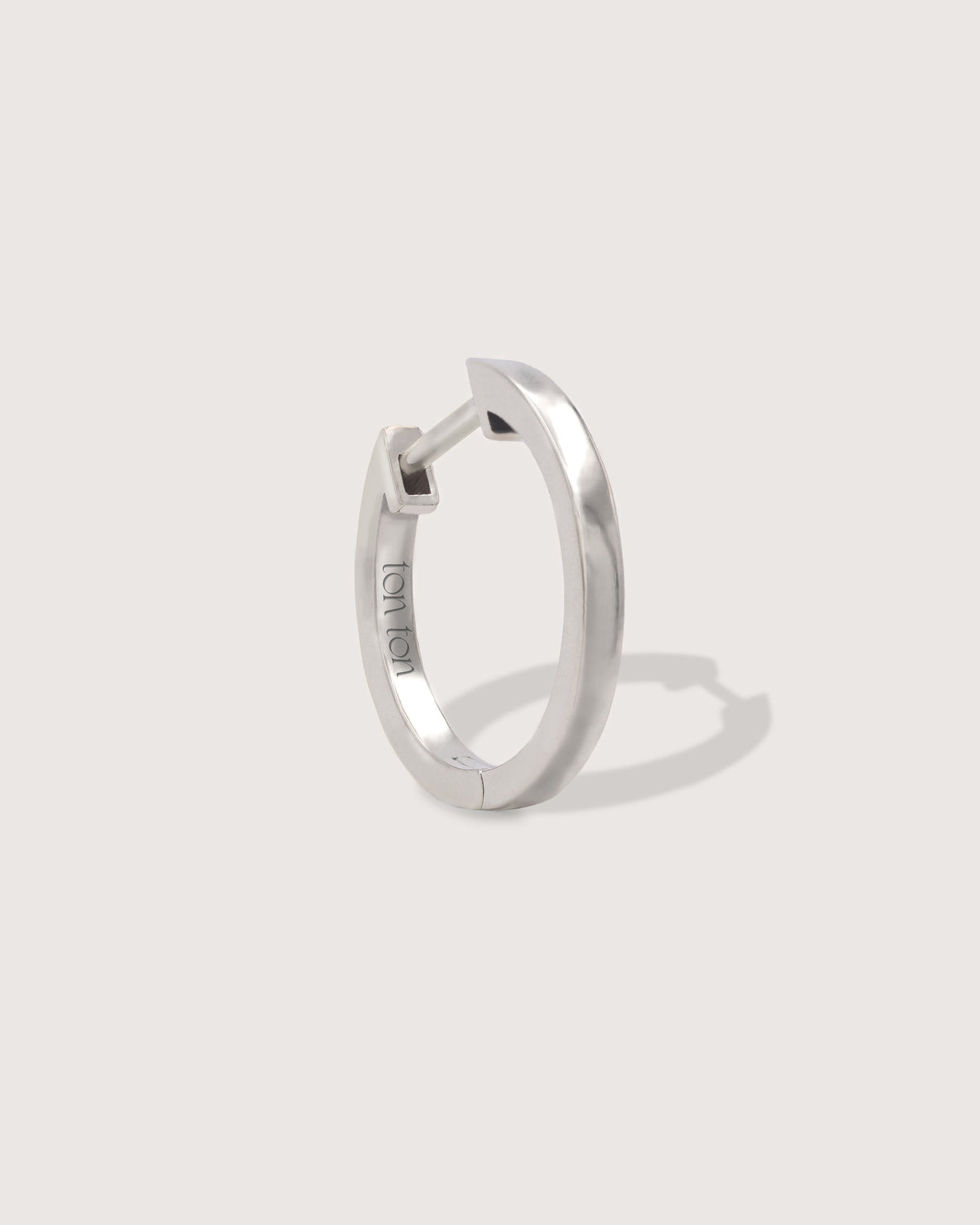 The Hoop earring in recycled solid 14K white gold, TON TON's essential hoop with a secure click closure.