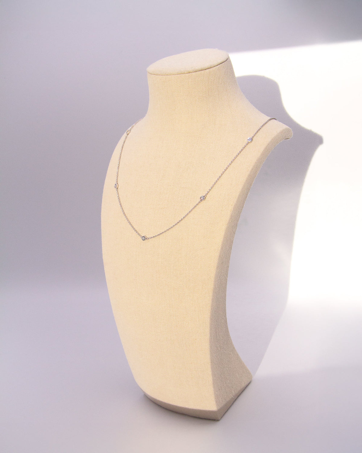 Close-up of the Bezel Diamond Station Necklace in recycled 18K white gold.
