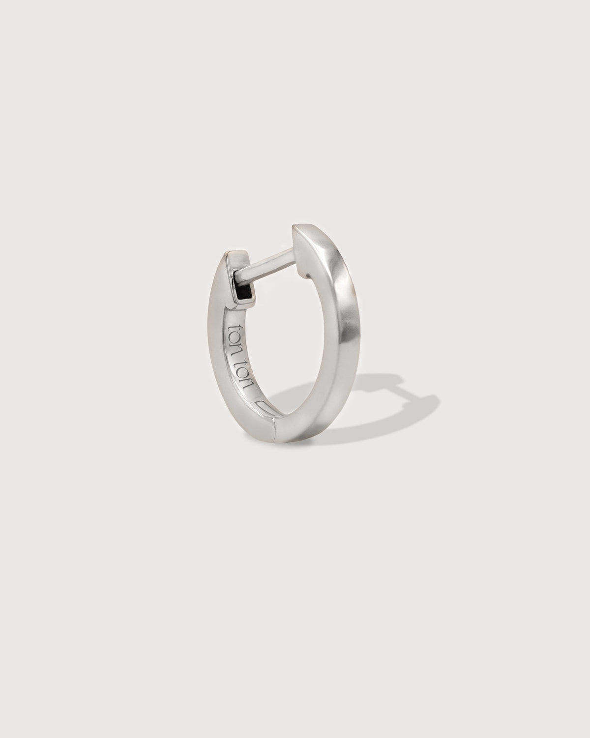 The Petite Hoop earring in recycled solid 14K white gold, a smaller take on The Hoop with a secure click closure.