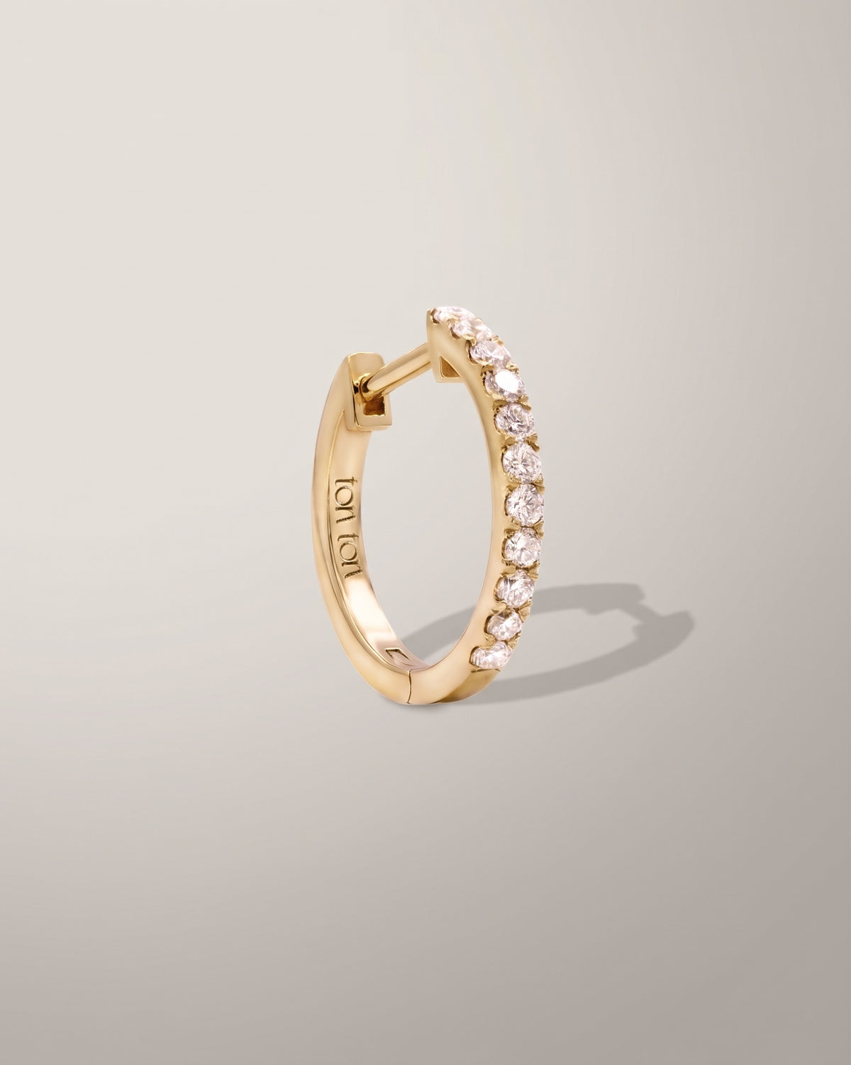 The Diamond Hoop earring in recycled solid 14K gold, set with 11 lab-grown diamonds.