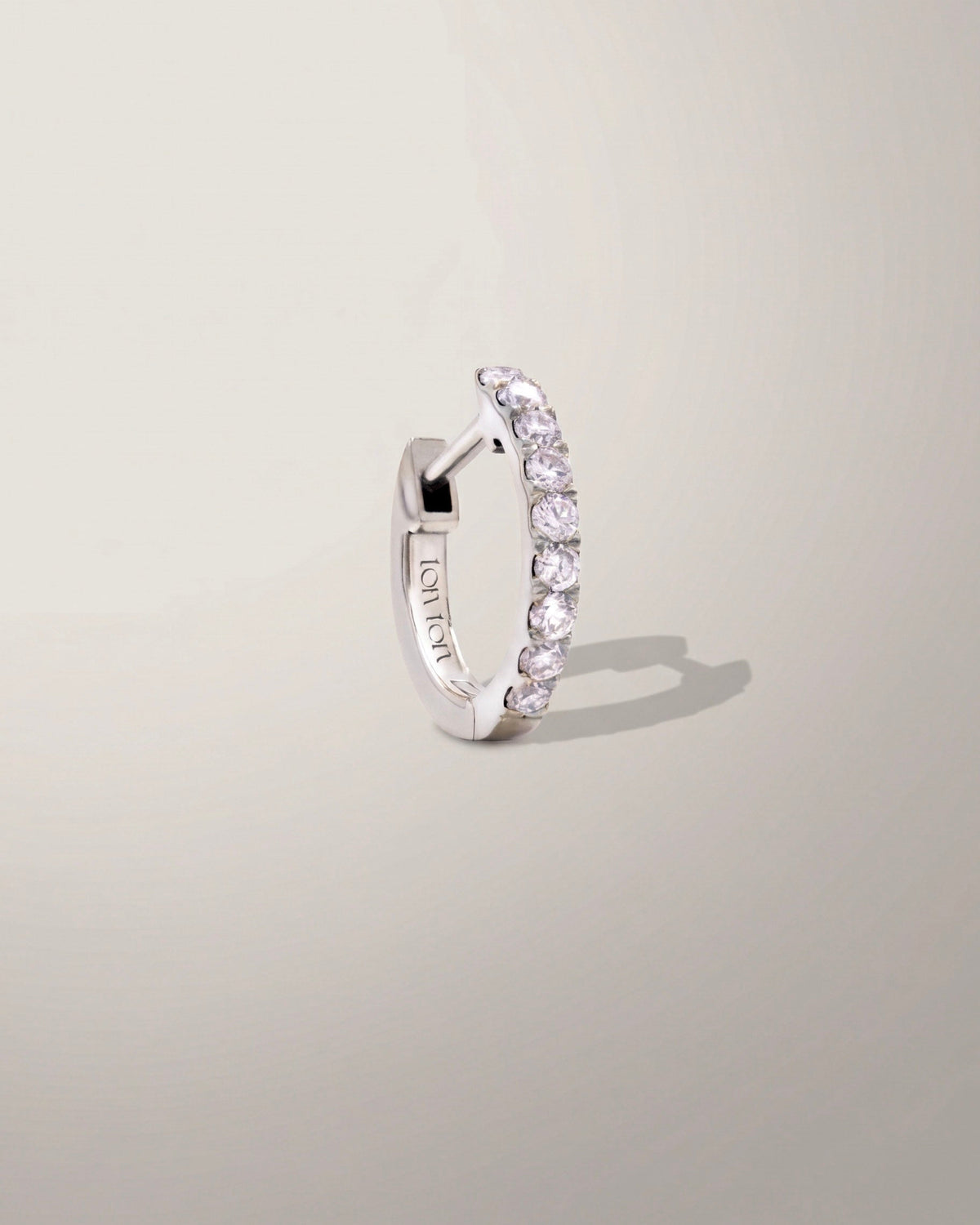 The Petite Diamond Hoop earring in recycled solid 14K white gold, set with 9 lab-grown diamonds.