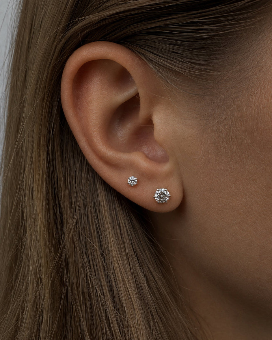 The Petite Solitaire Diamond Stud in a refined 6-prong setting, recycled 14K gold.