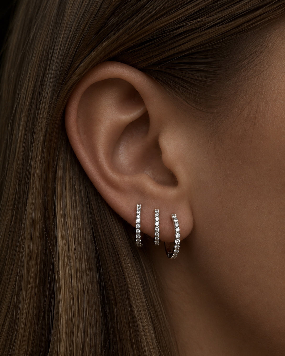 The Diamond Hoop earring family in recycled 14K gold and white gold, each set with lab-grown diamonds.