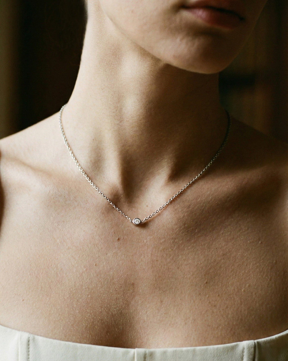 Close-up of the Bezel Diamond Necklace in recycled 18K white gold.