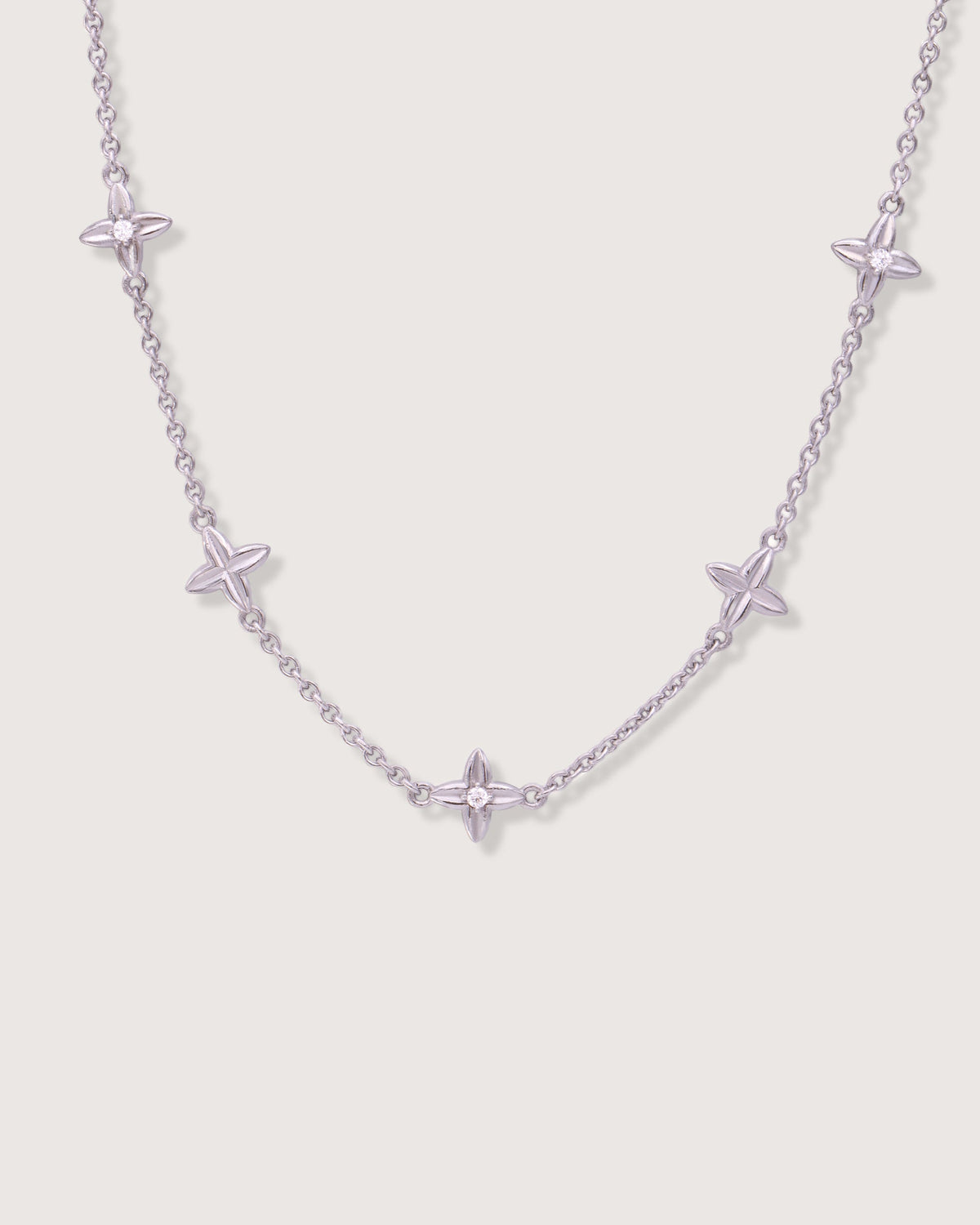 The Flora Station Bracelet in recycled solid 18K white gold, set with Flora motifs along the wrist.